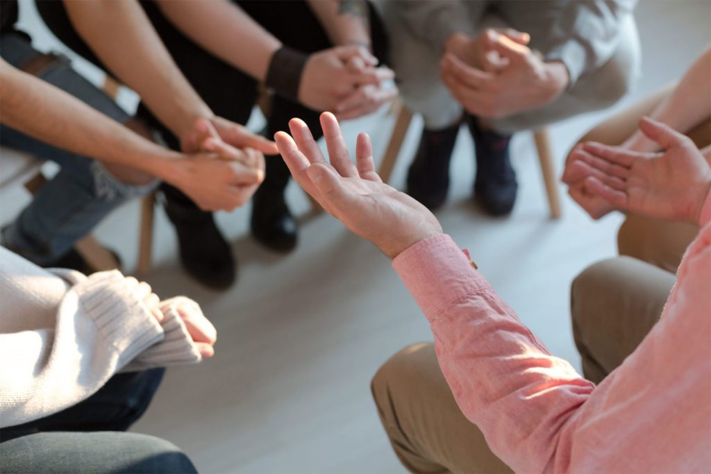 photo of mental health family support group sitting in circle during therapy session
