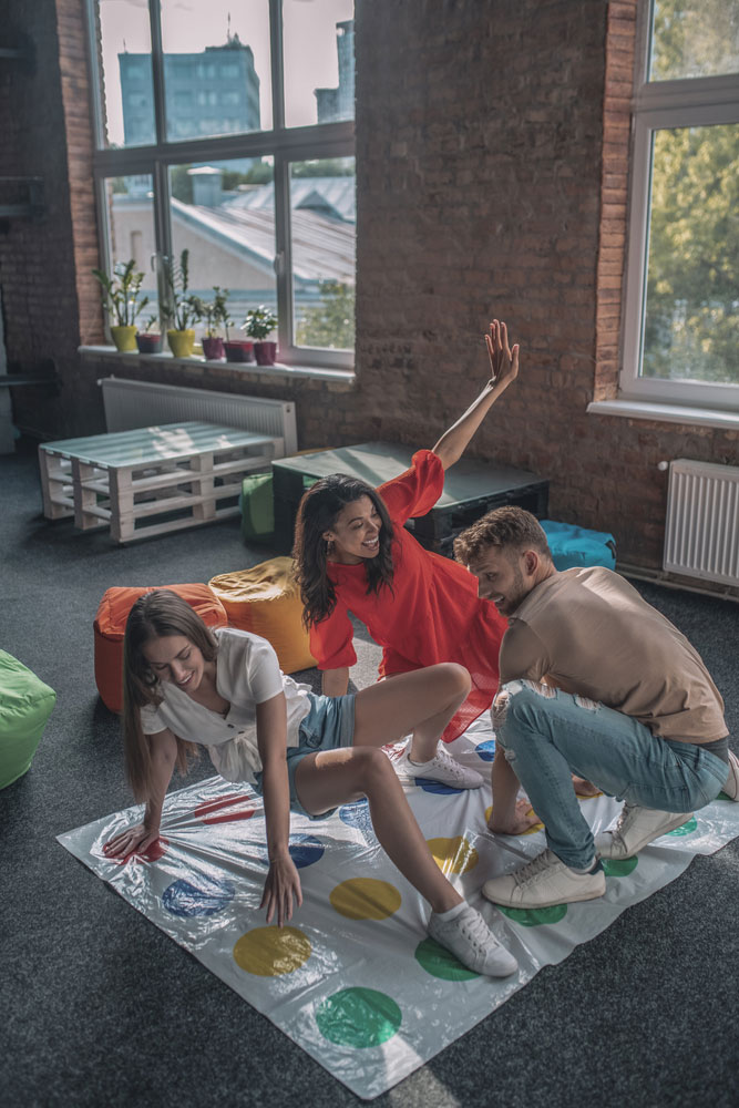 three friends playing twister game