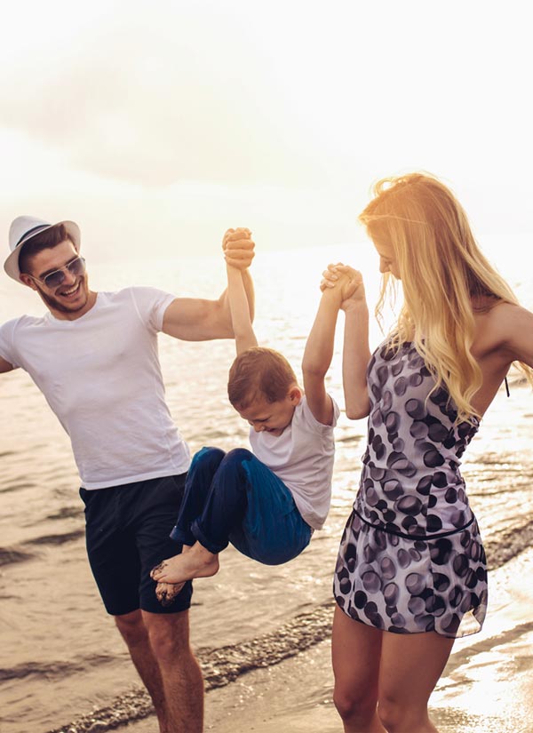 happy family playing near the ocean