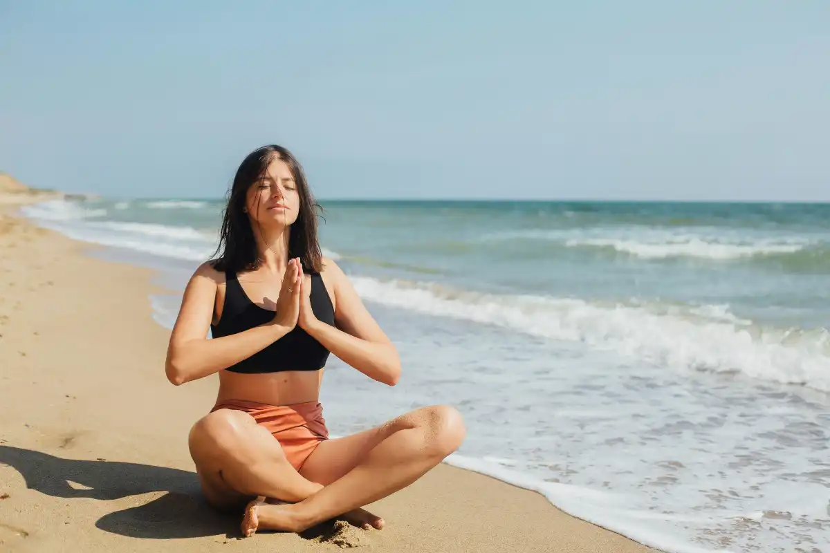 woman meditating on the sea shore