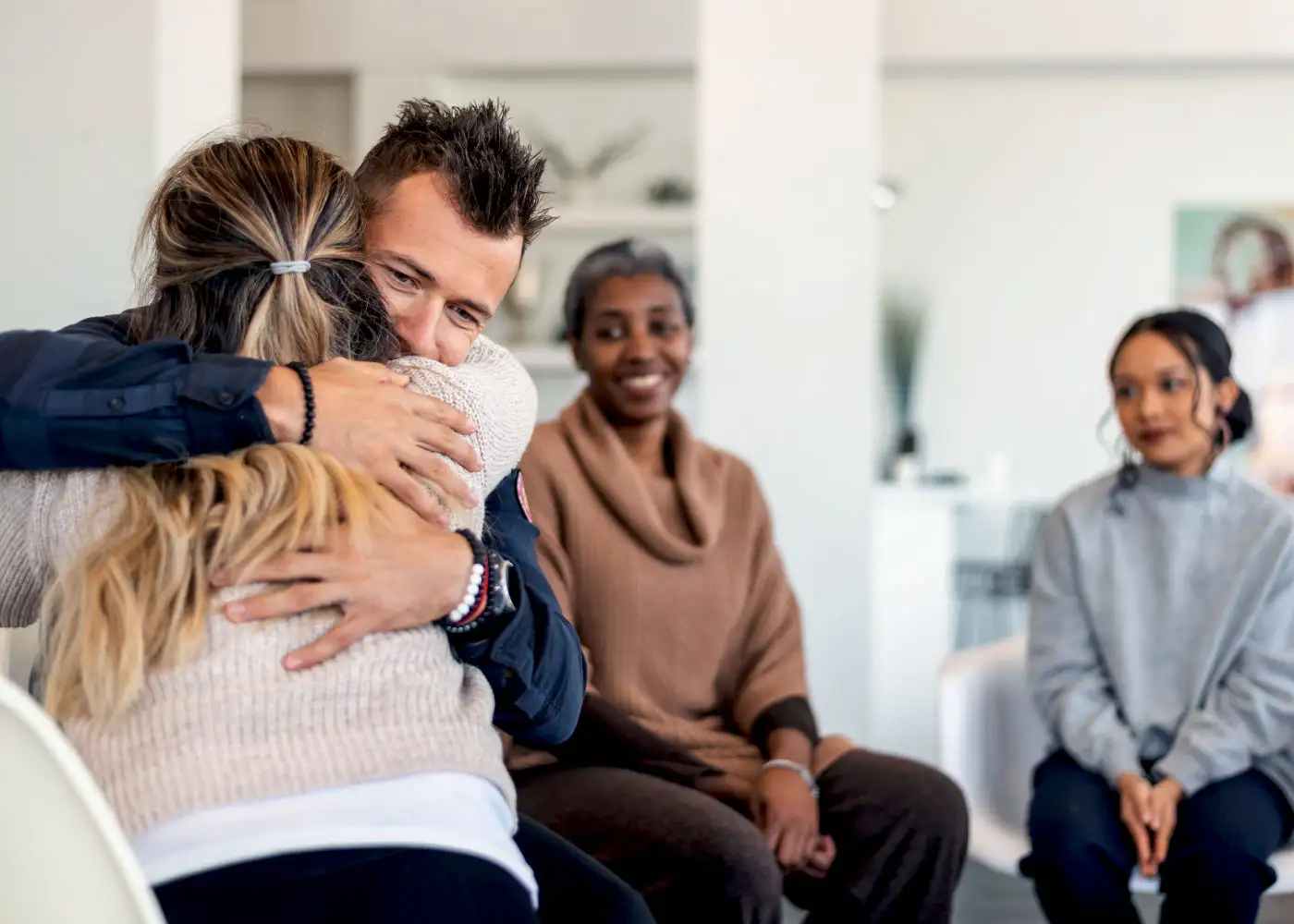 In a waiting room a man hugs a woman ar the Compassion Recovery Center in Laguna Hills