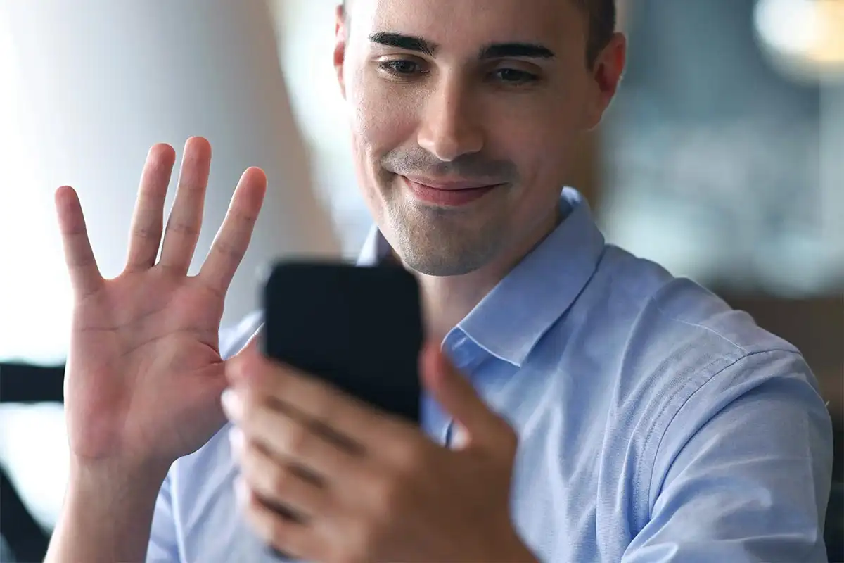 a male client attending a Virtual IOP in California for Addiction Recovery using his mobile phone