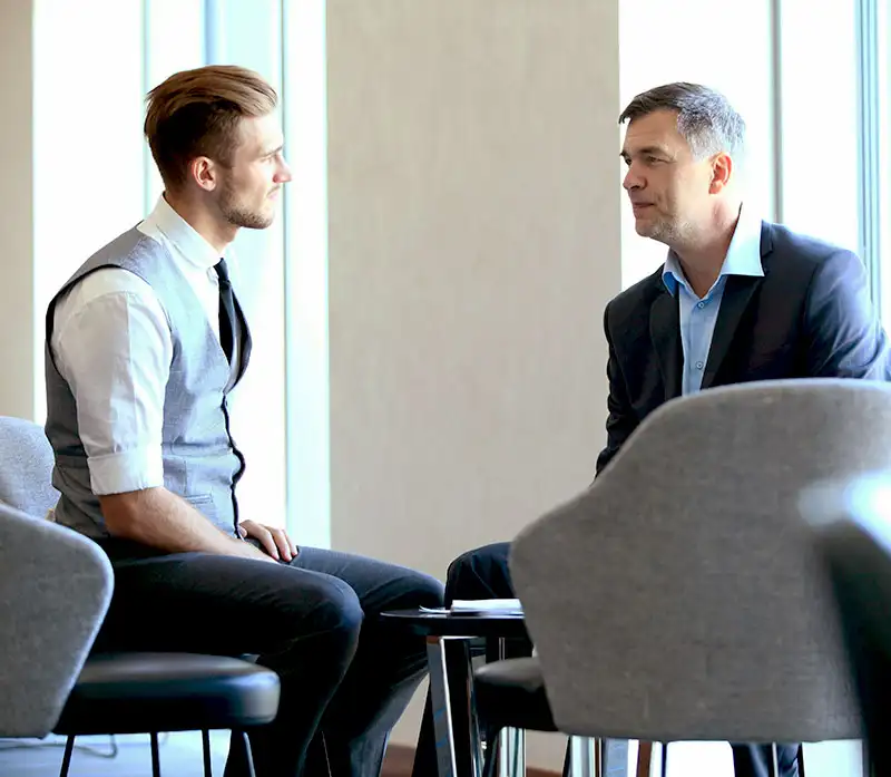 a male employee talking to his employer about his plan going to rehab