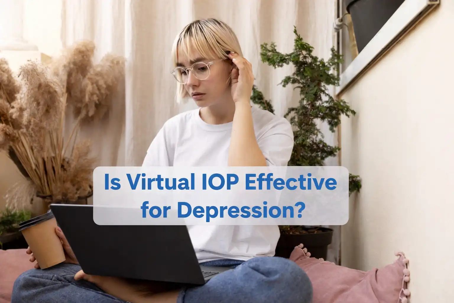 Person attending virtual IOP therapy session on laptop for depression treatment at home