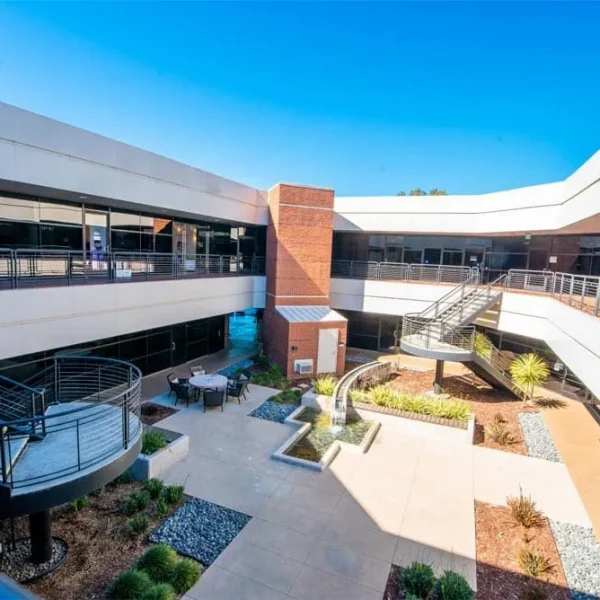 Modern outdoor courtyard at Compassion Recovery Centers in Orange County, featuring a serene fountain, seating area, and professional clinical offices for outpatient mental health care.